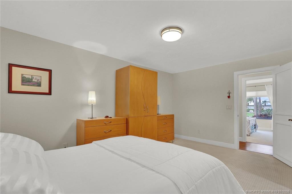 3060 Southeast Darien Road Port St. Lucie, FL 34952 - Photo 23 of 52 a bedroom with a bed and wooden floor