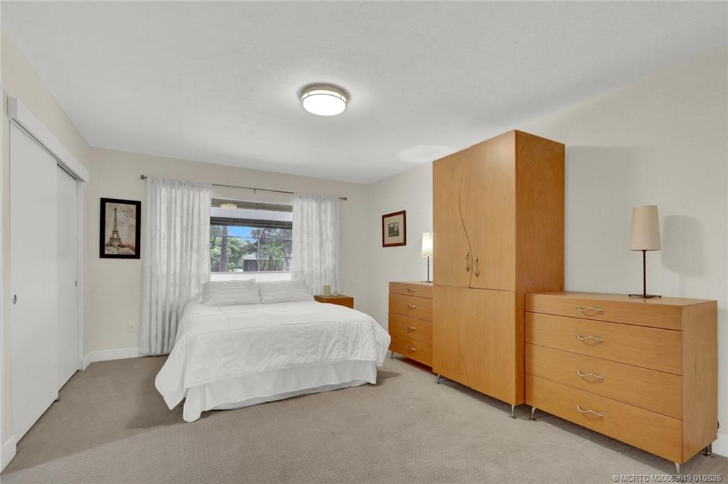 3060 Southeast Darien Road Port St. Lucie, FL 34952 - Photo 25 of 52 a bedroom with a bed and a dresser
