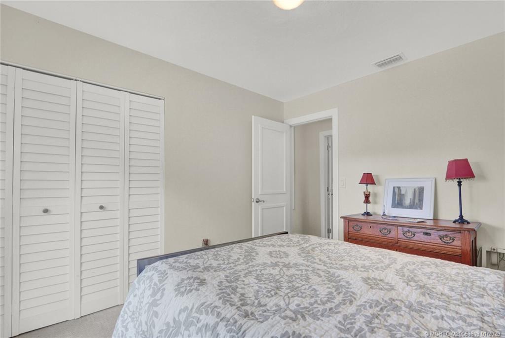 3060 Southeast Darien Road Port St. Lucie, FL 34952 - Photo 26 of 52 a bedroom with a bed and a dresser