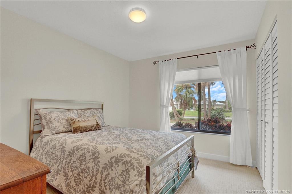 3060 Southeast Darien Road Port St. Lucie, FL 34952 - Photo 27 of 52 a bedroom with a large bed and a window