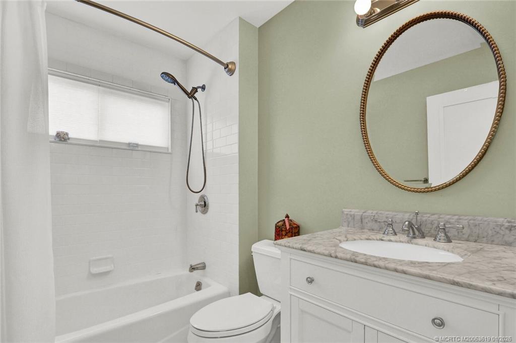 3060 Southeast Darien Road Port St. Lucie, FL 34952 - Photo 34 of 52 a bathroom with a granite countertop sink toilet and a mirror