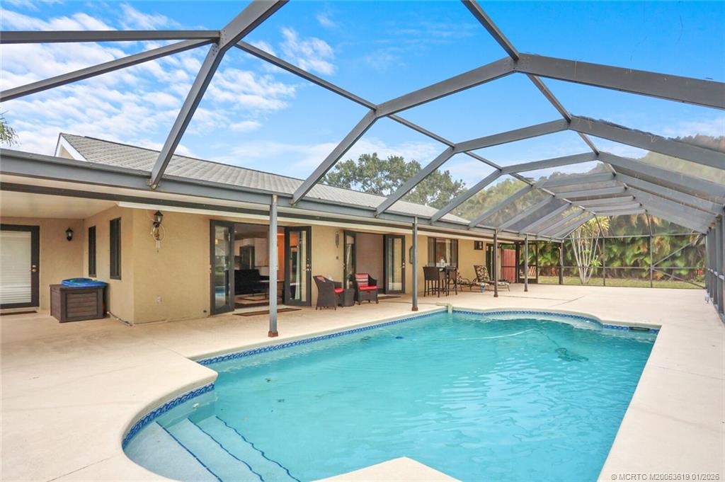 3060 Southeast Darien Road Port St. Lucie, FL 34952 - Photo 36 of 52 a view of a house with a backyard porch and sitting area