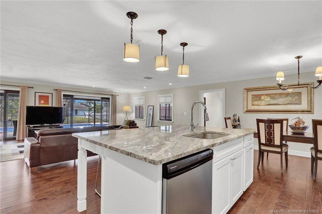 3060 Southeast Darien Road Port St. Lucie, FL 34952 - Photo 9 of 52 a view of center island of a kitchen with granite countertop living room and chairs