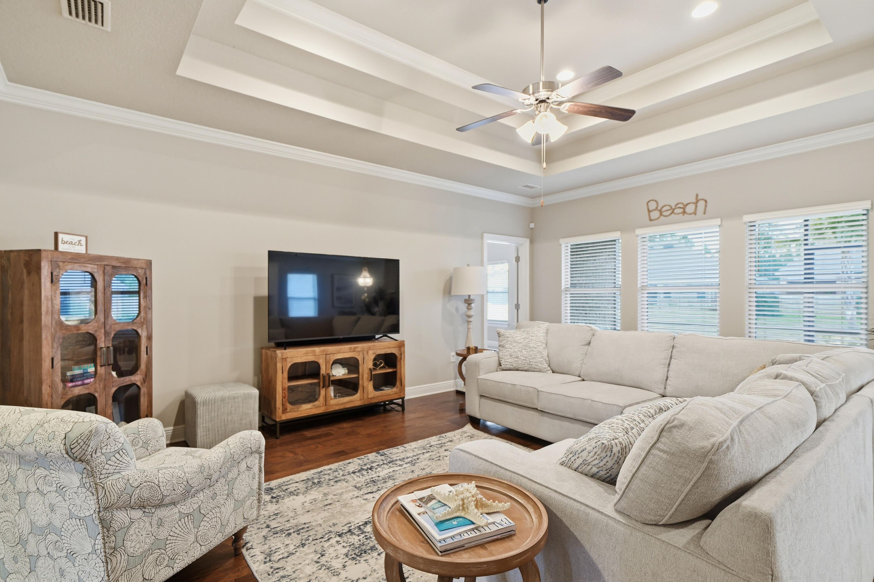 102 Wayne Trail Santa Rosa Beach, FL 32459 - Photo 12 of 35 a living room with furniture a flat screen tv and a large window