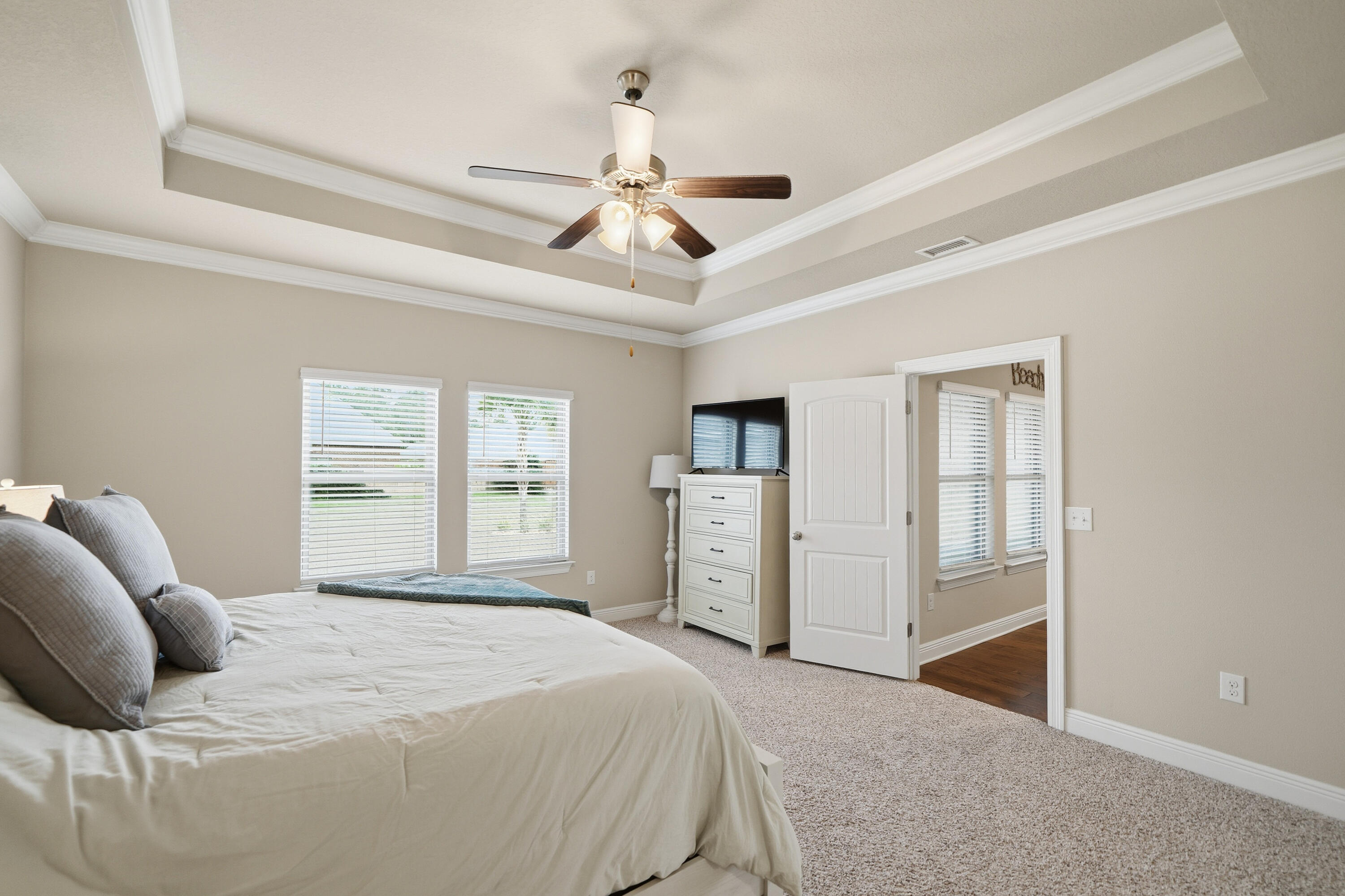 102 Wayne Trail Santa Rosa Beach, FL 32459 - Photo 19 of 35 a bedroom with a large bed and a ceiling fan