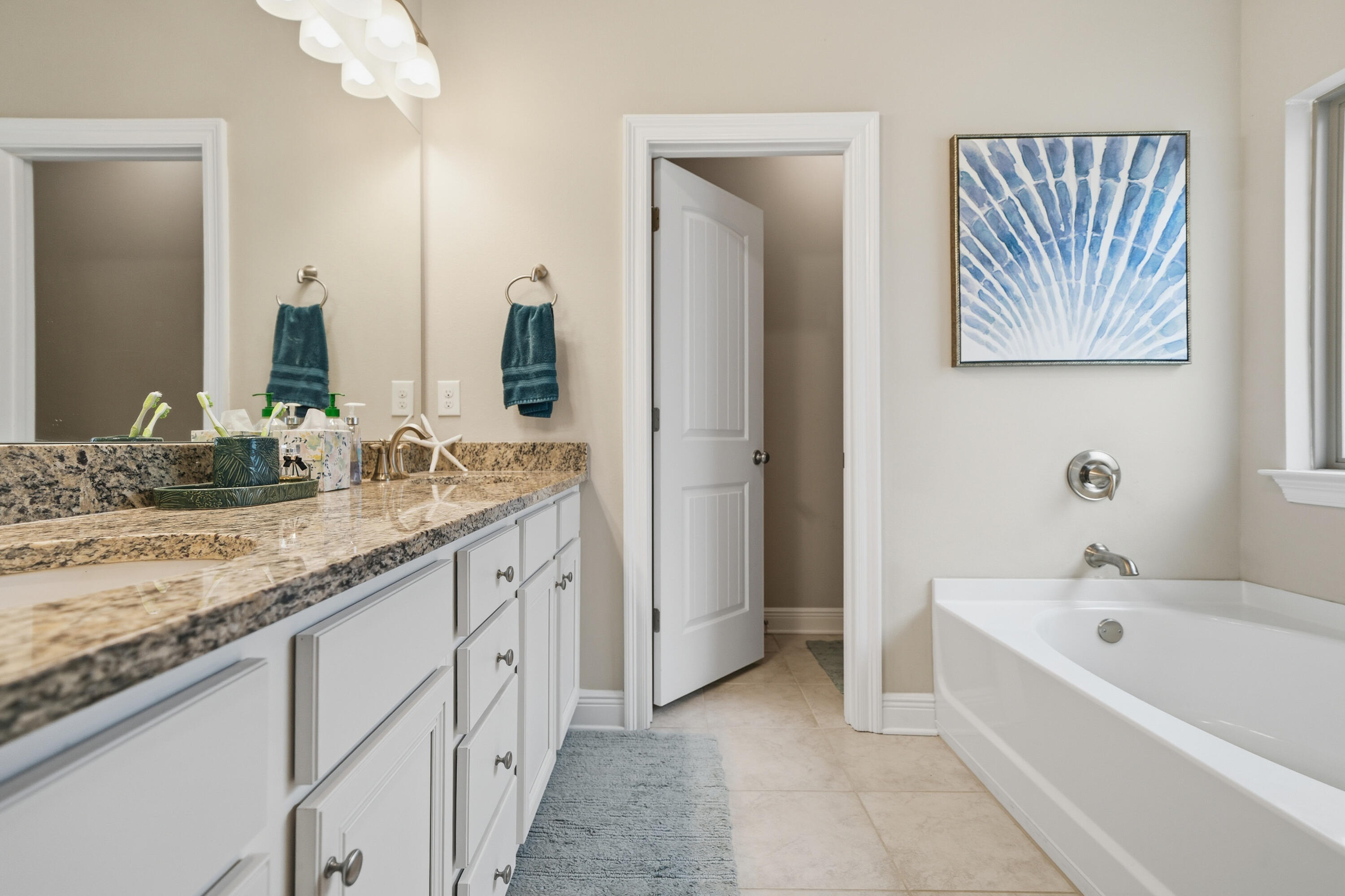 102 Wayne Trail Santa Rosa Beach, FL 32459 - Photo 20 of 35 a spacious bathroom with a granite countertop sink and a mirror