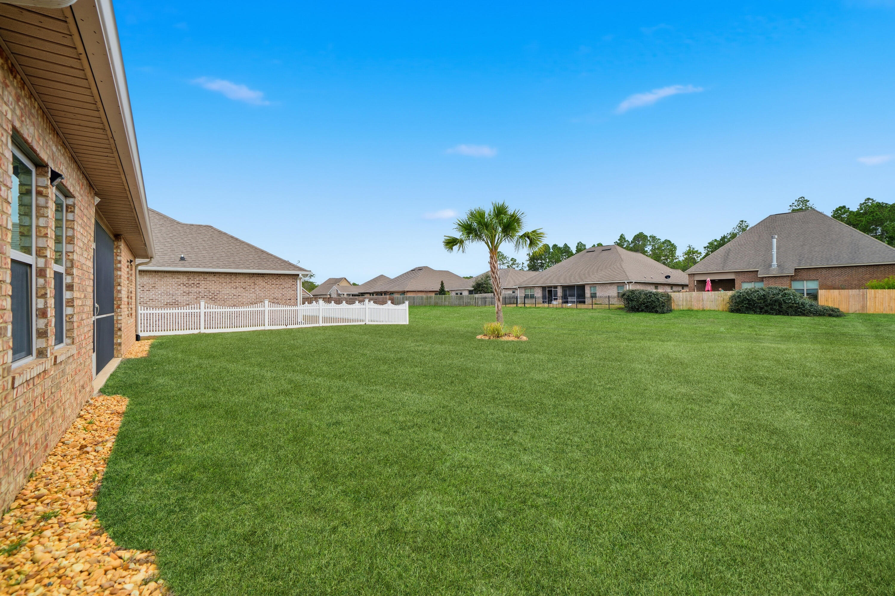 102 Wayne Trail Santa Rosa Beach, FL 32459 - Photo 33 of 35 a view of an house with backyard space and garden