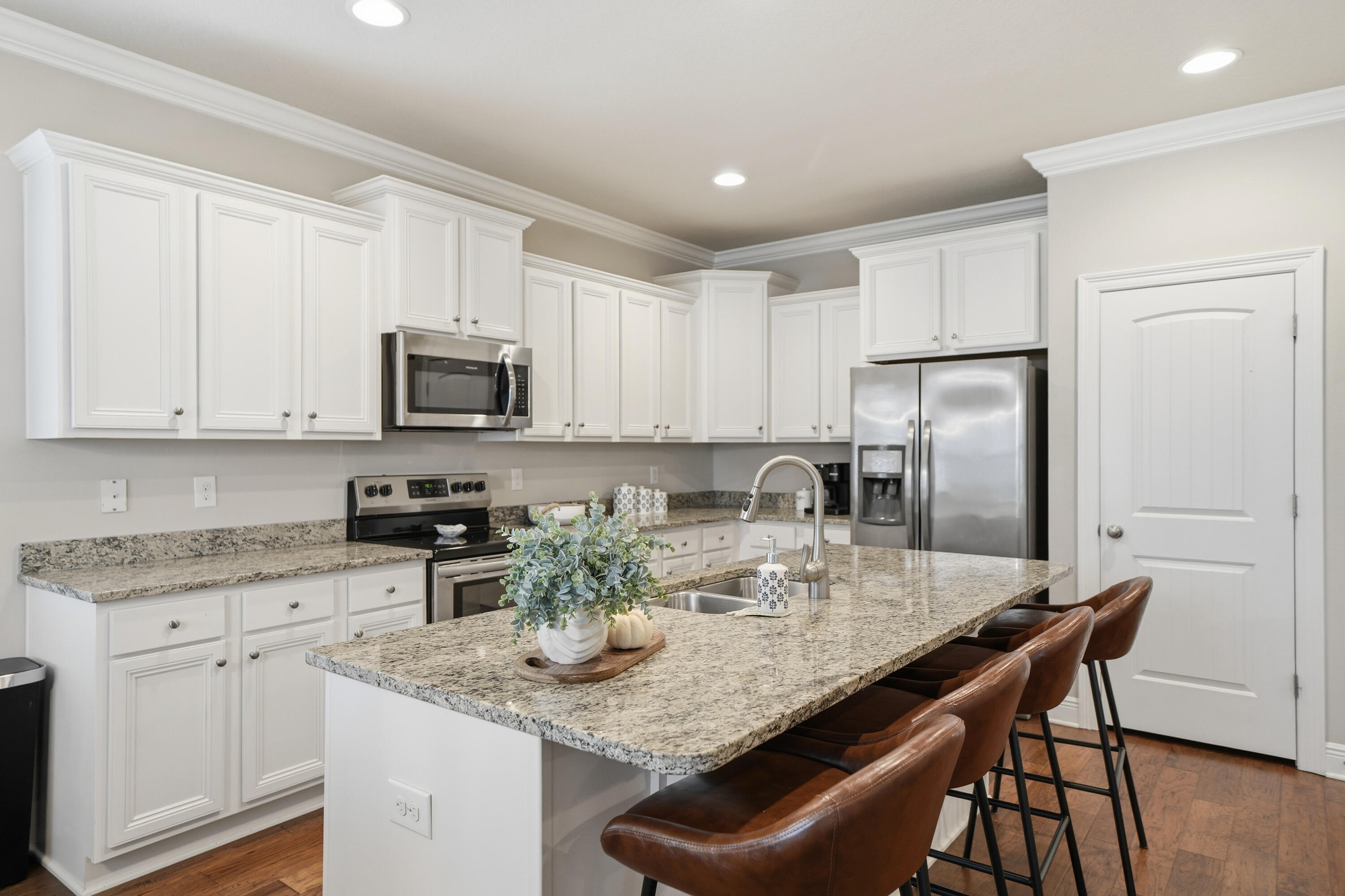 102 Wayne Trail Santa Rosa Beach, FL 32459 - Photo 5 of 35 a kitchen with kitchen island granite countertop stainless steel appliances cabinets a sink and a stove