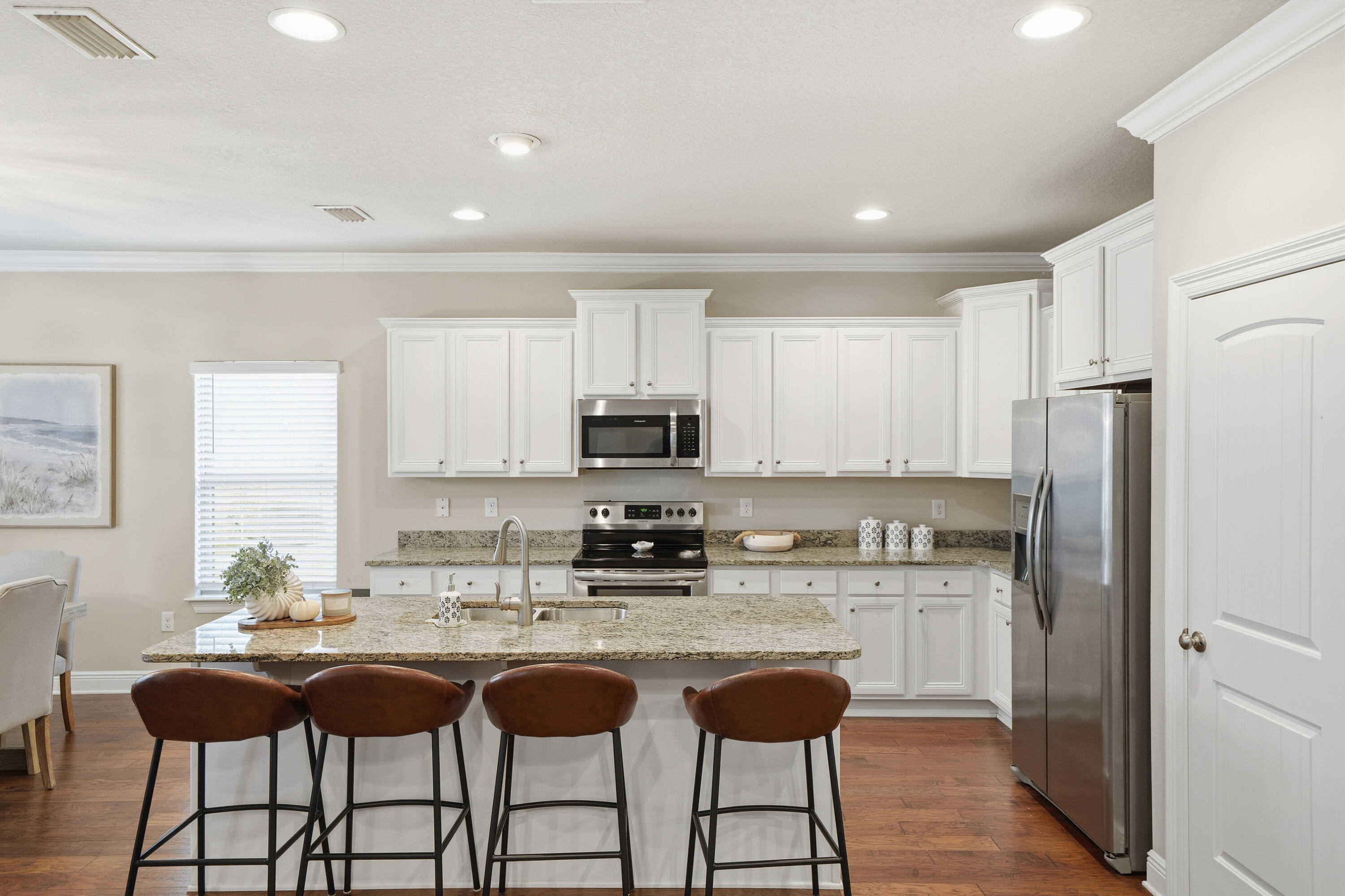 102 Wayne Trail Santa Rosa Beach, FL 32459 - Photo 7 of 35 a kitchen with stainless steel appliances granite countertop a sink a stove a refrigerator cabinets and dining table