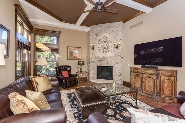 a living room with furniture a fireplace and a flat screen tv