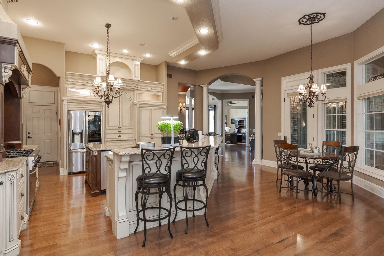 47 Stonebrook Court Bloomington, IL 61704 - Photo 27 of 73 a view of a dining room and livingroom with furniture wooden floor a chandelier