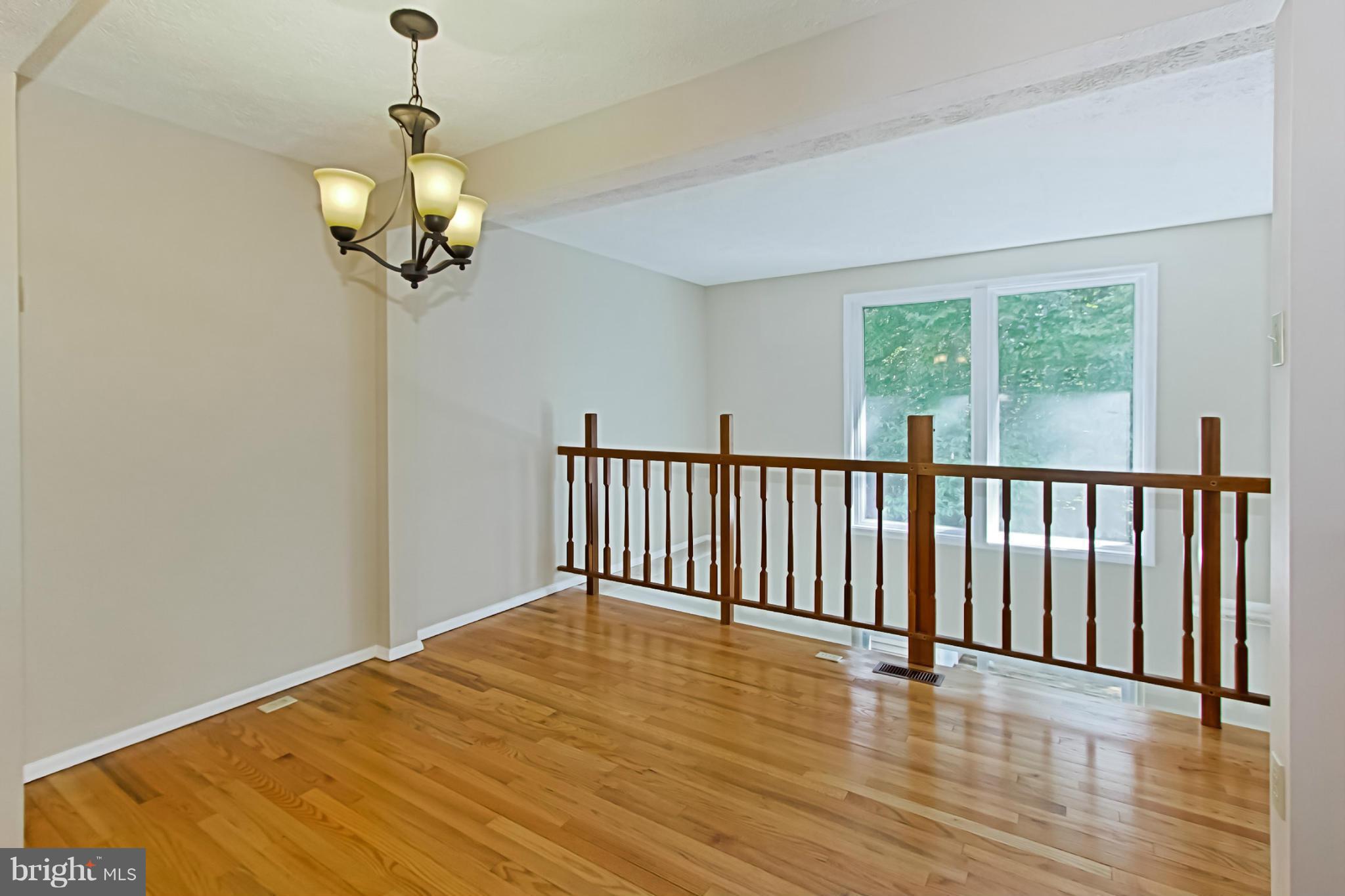 8317 Windfall Road Springfield, VA 22153 - Photo 3 of 19 a view of a room with wooden floor and a chandelier
