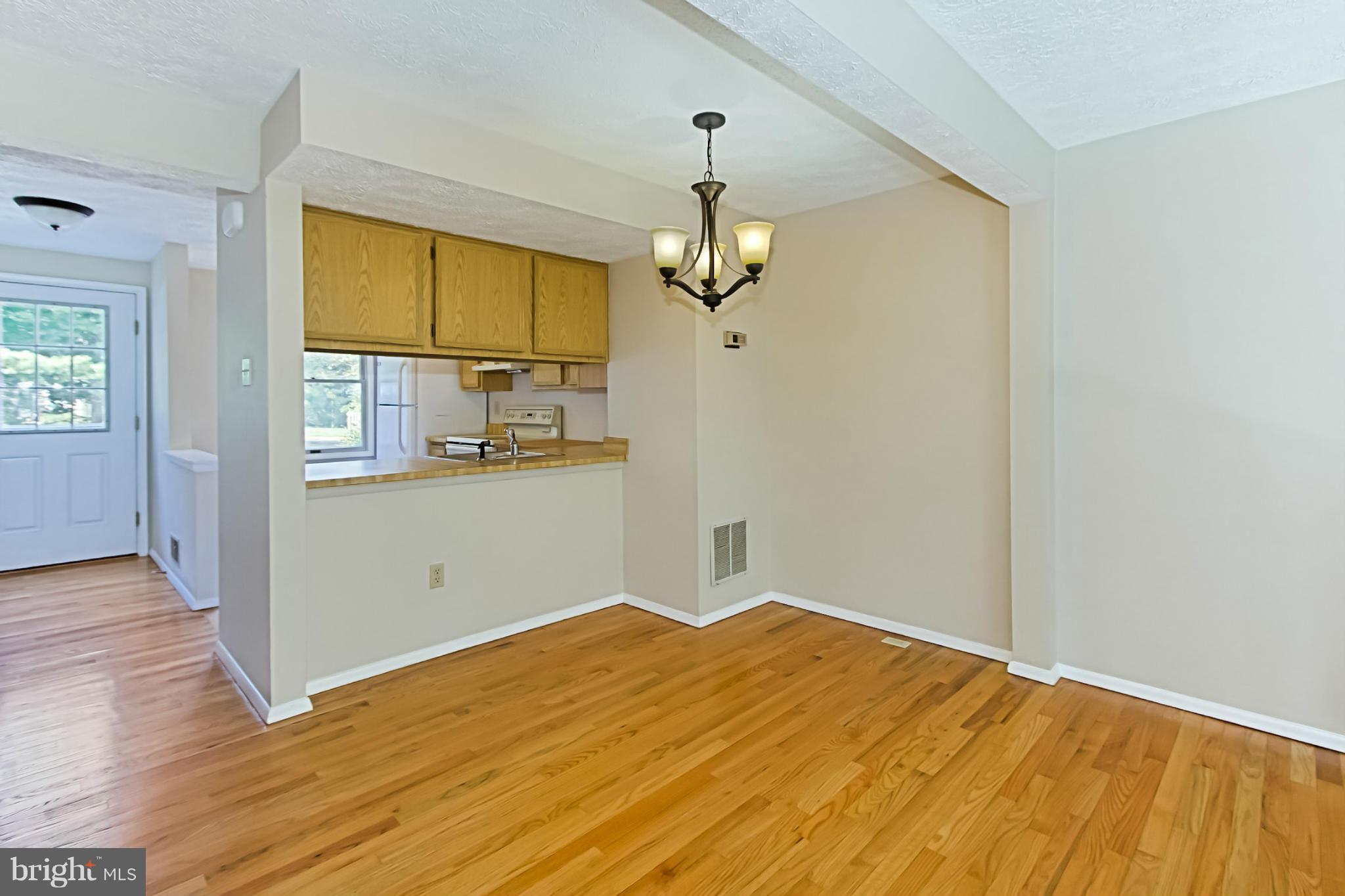 8317 Windfall Road Springfield, VA 22153 - Photo 4 of 19 a bedroom with a bed and wooden floor