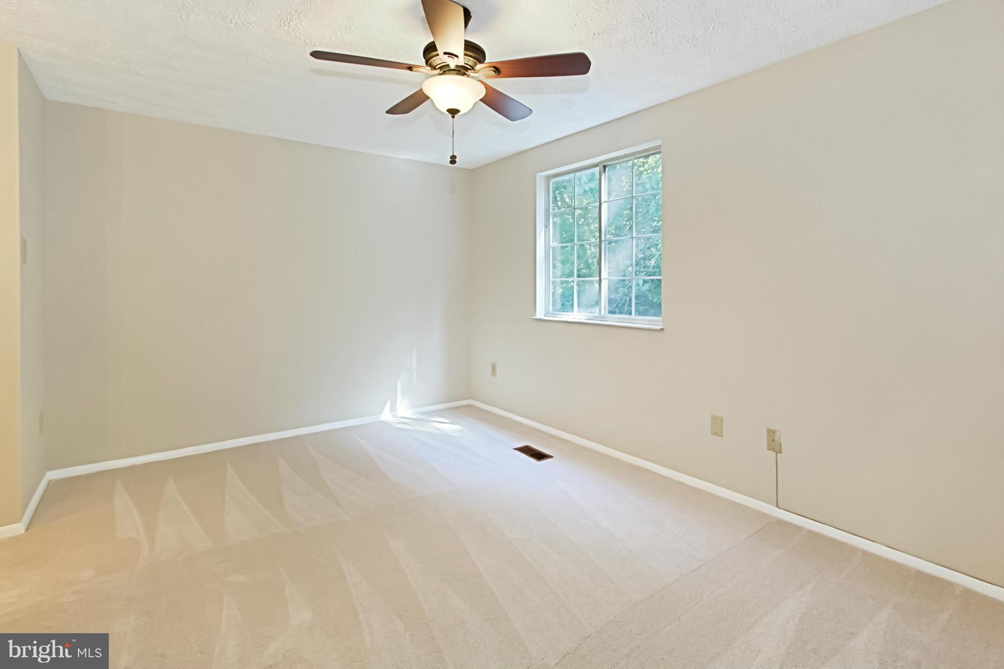 8317 Windfall Road Springfield, VA 22153 - Photo 7 of 19 an empty room with windows and fan