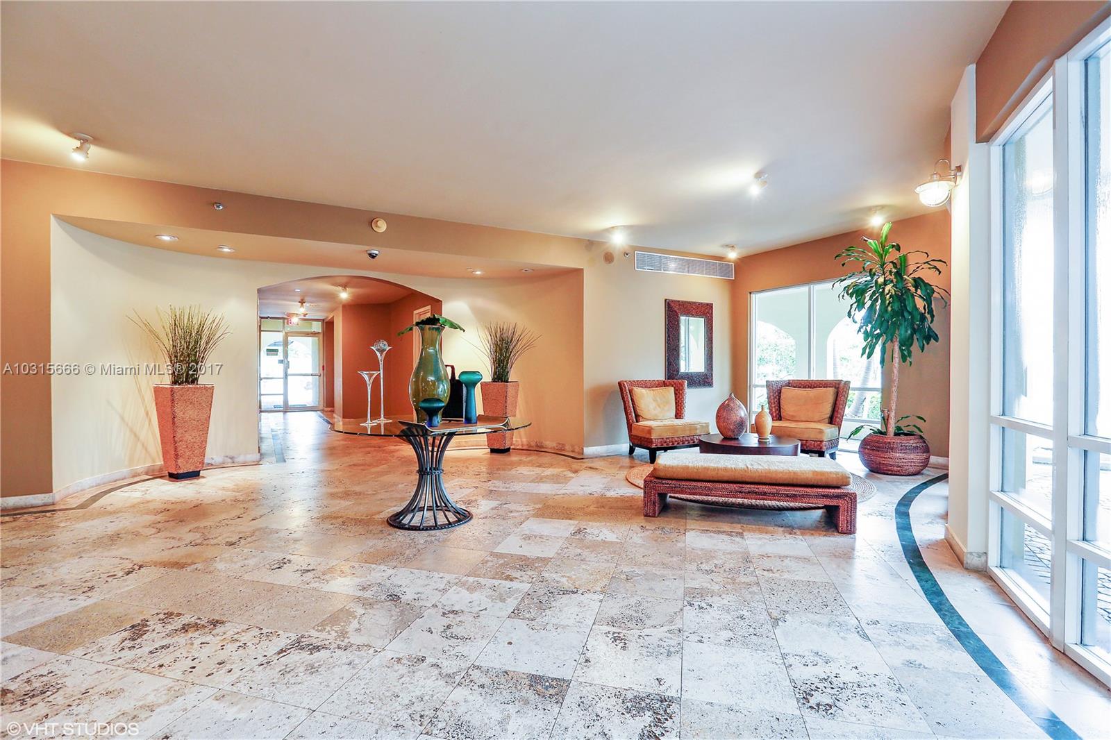 2351 Douglas Road, Unit 1110 Miami, FL 33145 - Photo 2 of 10 a living room with furniture and a fireplace