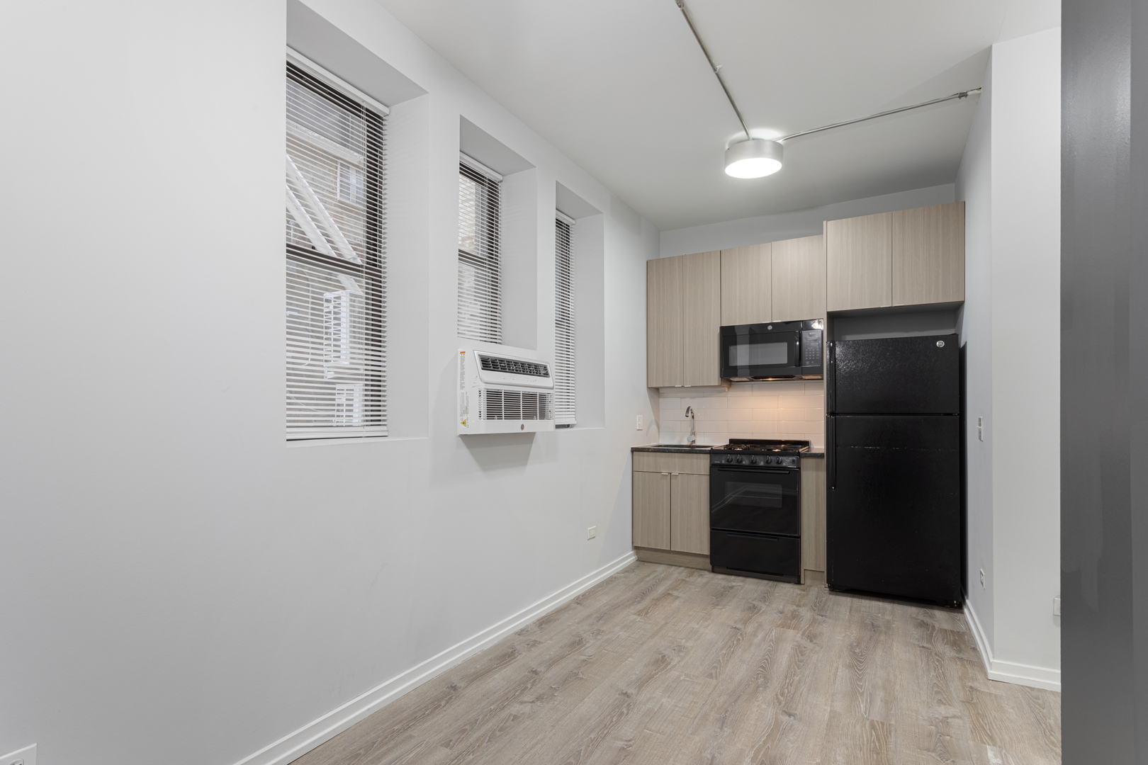 4875 North Magnolia Avenue, Unit 113 Chicago, IL 60640 - Photo 2 of 8 a kitchen with a refrigerator and a stove top oven
