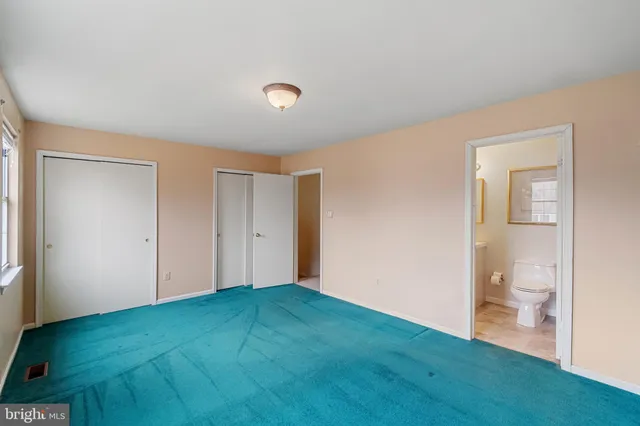 a view of a big room with wooden floor and a bathroom