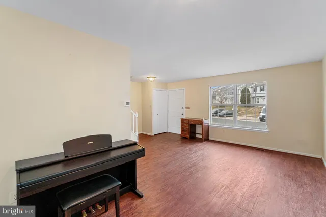 a living room with furniture and a piano