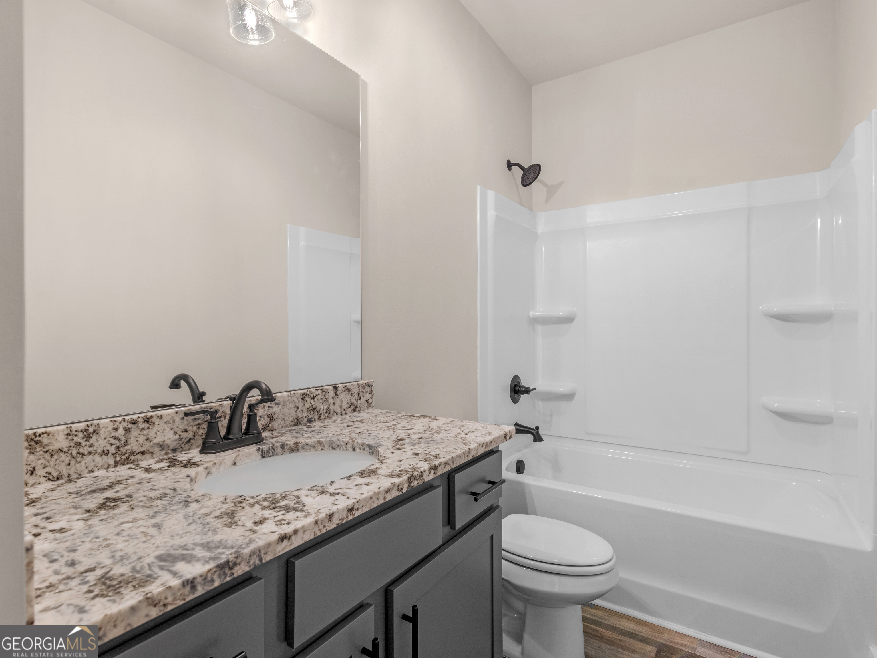 160 Loyd Road Mansfield, GA 30056 - Photo 36 of 53 a bathroom with a granite countertop sink a toilet and a bathtub