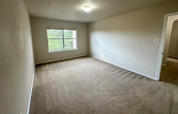 a view of a livingroom with a ceiling fan and window