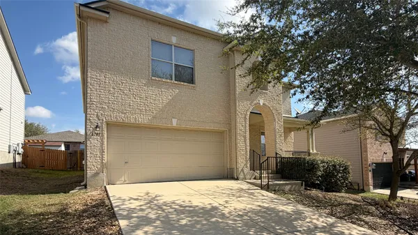 a front view of a house with garage