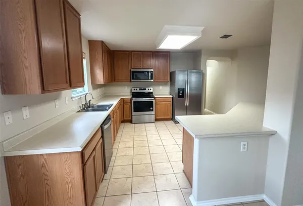 a kitchen with stainless steel appliances a refrigerator and a sink