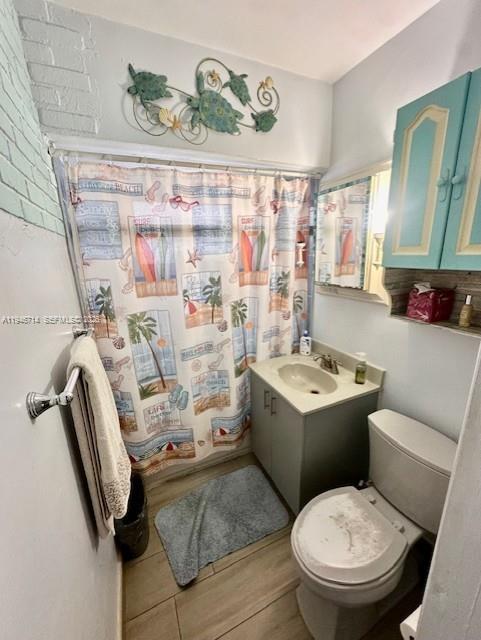 7215 Southwest 23rd Street Miami, FL 33155 - Photo 7 of 10 a bathroom with a sink mirror vanity and toilet