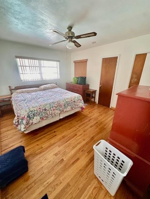 7215 Southwest 23rd Street Miami, FL 33155 - Photo 9 of 10 a bedroom with a bed and wooden floor