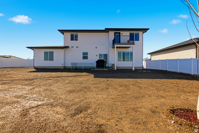 3902 West 825 North West Point, UT 84015 - Photo 34 of 49 Back of property with a balcony, a fenced backyard, and a patio area