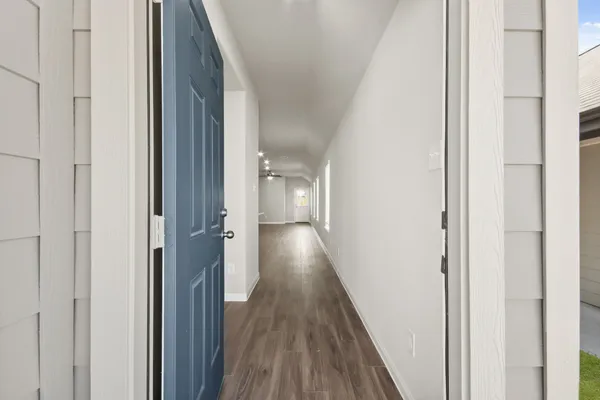 a view of a hallway with wooden floor