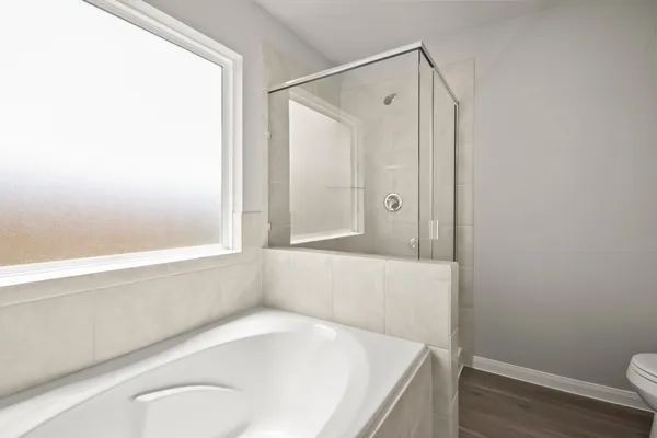 a bathroom with a tub and shower