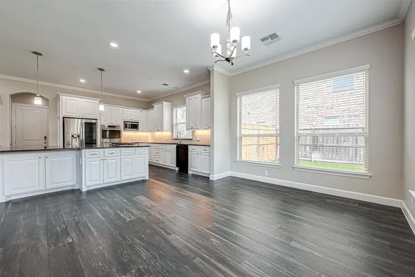 a view of kitchen with cabinets and wooden floor