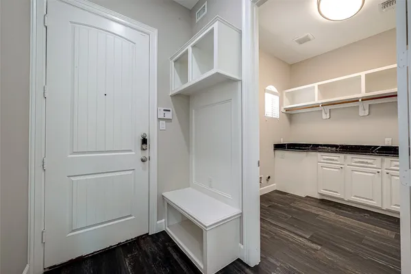 a kitchen with white cabinets and white appliances