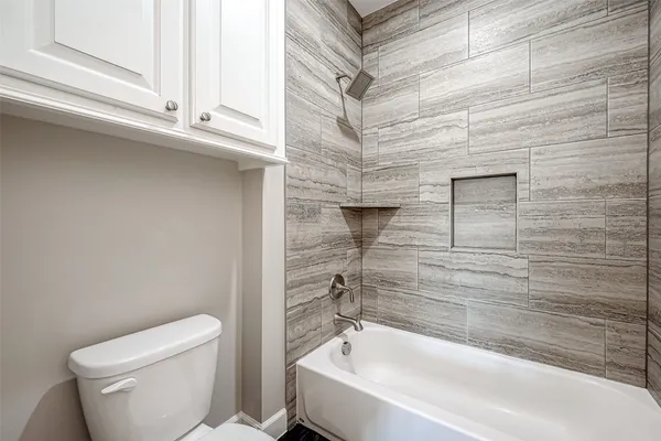 a bathroom with a toilet and a bathtub