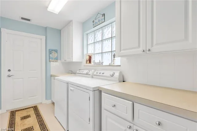 a utility room with sink dryer and washer