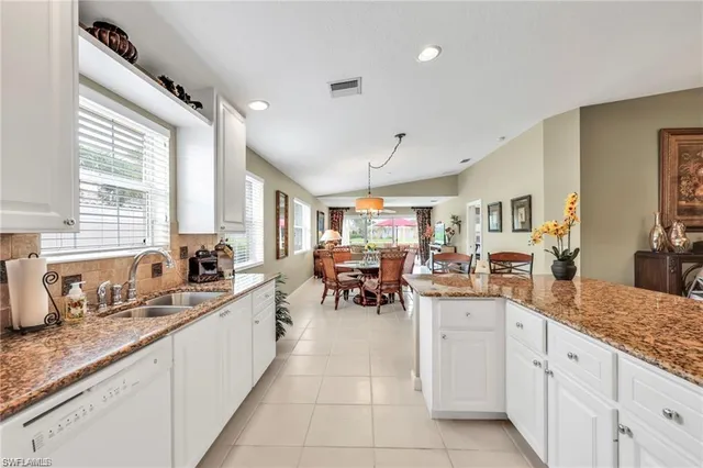a large white kitchen with lots of counter top space