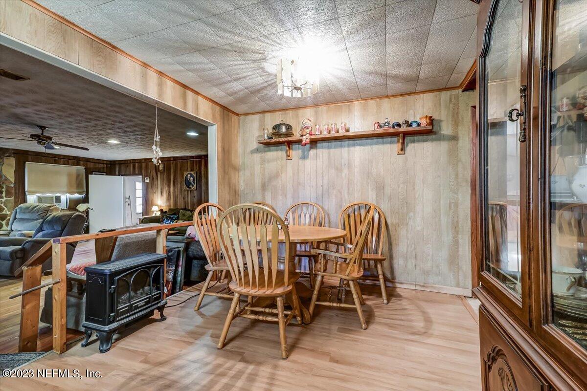 86290 Weldon Road Yulee, FL 32097 - Photo 11 of 46 a dining room with furniture a chandelier and wooden floor