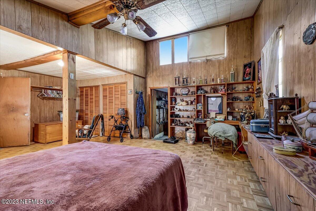 86290 Weldon Road Yulee, FL 32097 - Photo 15 of 46 a bed room with a bed and a large mirror