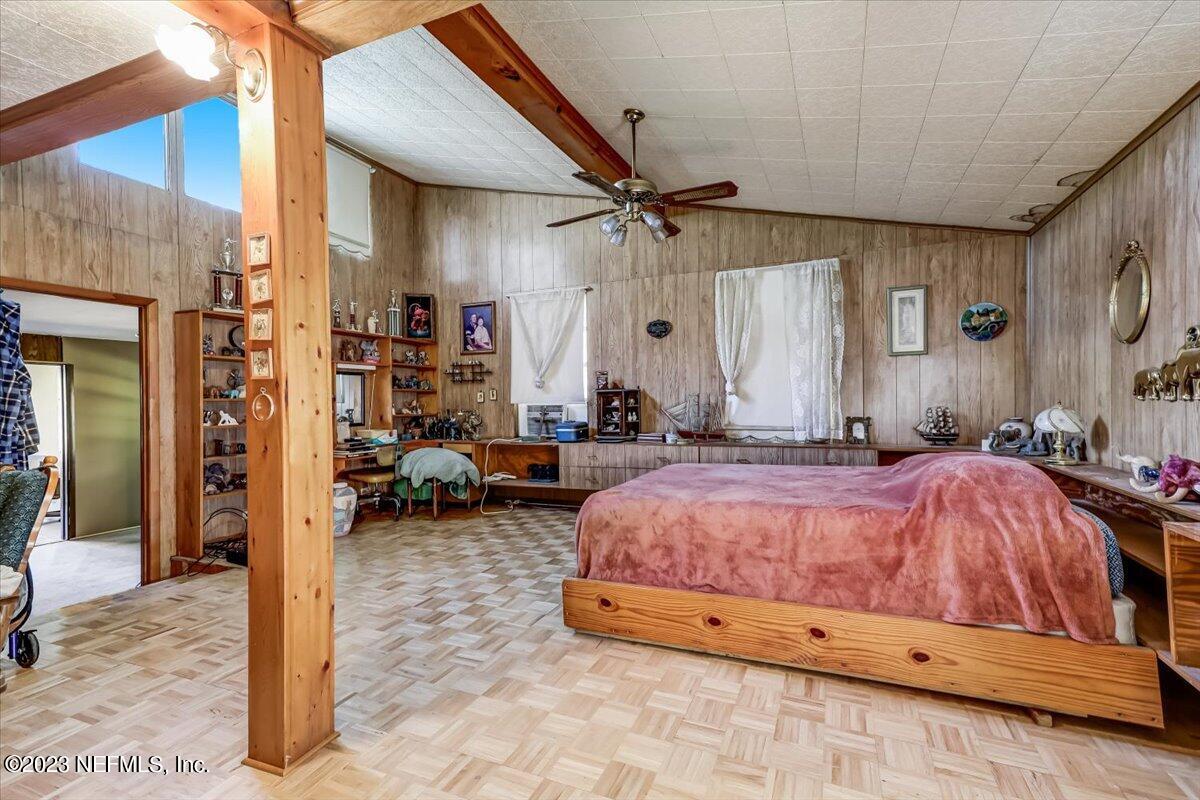 86290 Weldon Road Yulee, FL 32097 - Photo 18 of 46 a spacious bedroom with a bed and a mirror