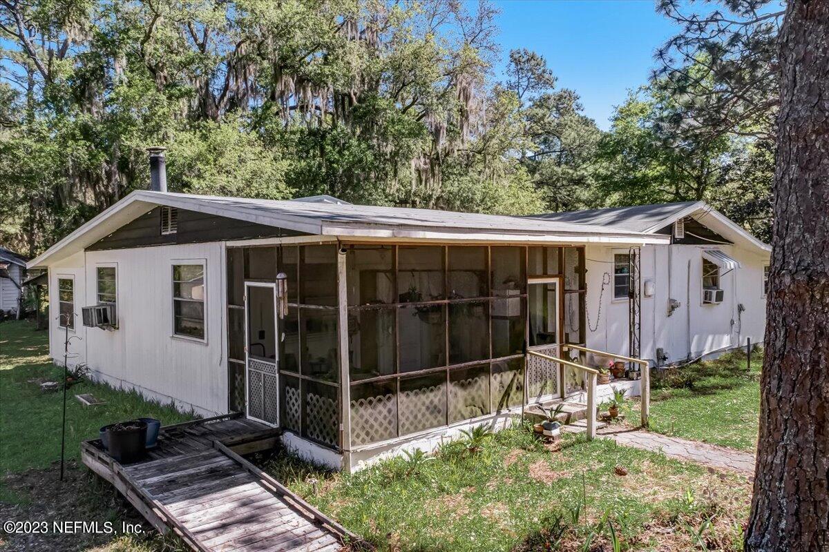 86290 Weldon Road Yulee, FL 32097 - Photo 23 of 46 a view of a small house with yard in front of it