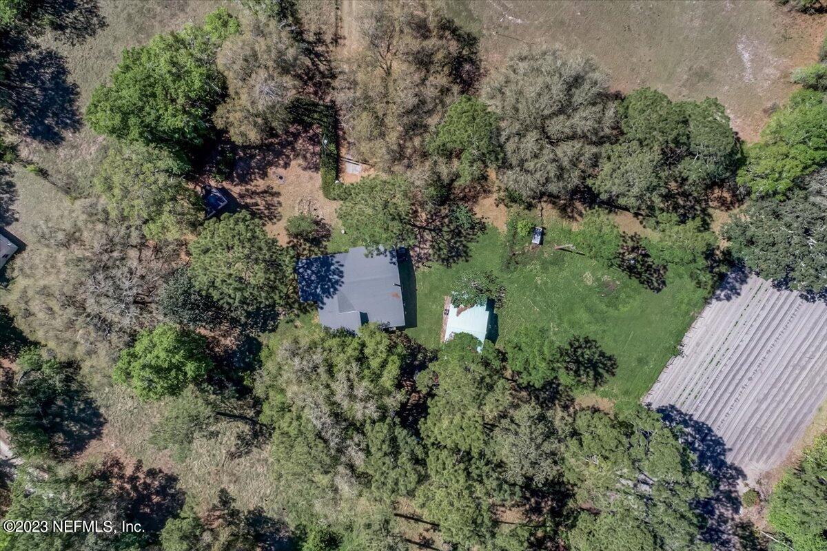 86290 Weldon Road Yulee, FL 32097 - Photo 32 of 46 an aerial view of a house with yard and outdoor seating