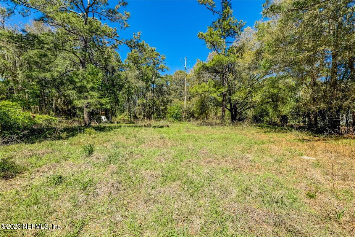86290 Weldon Road Yulee, FL 32097 - Photo 35 of 46 a view of outdoor space with deck and yard
