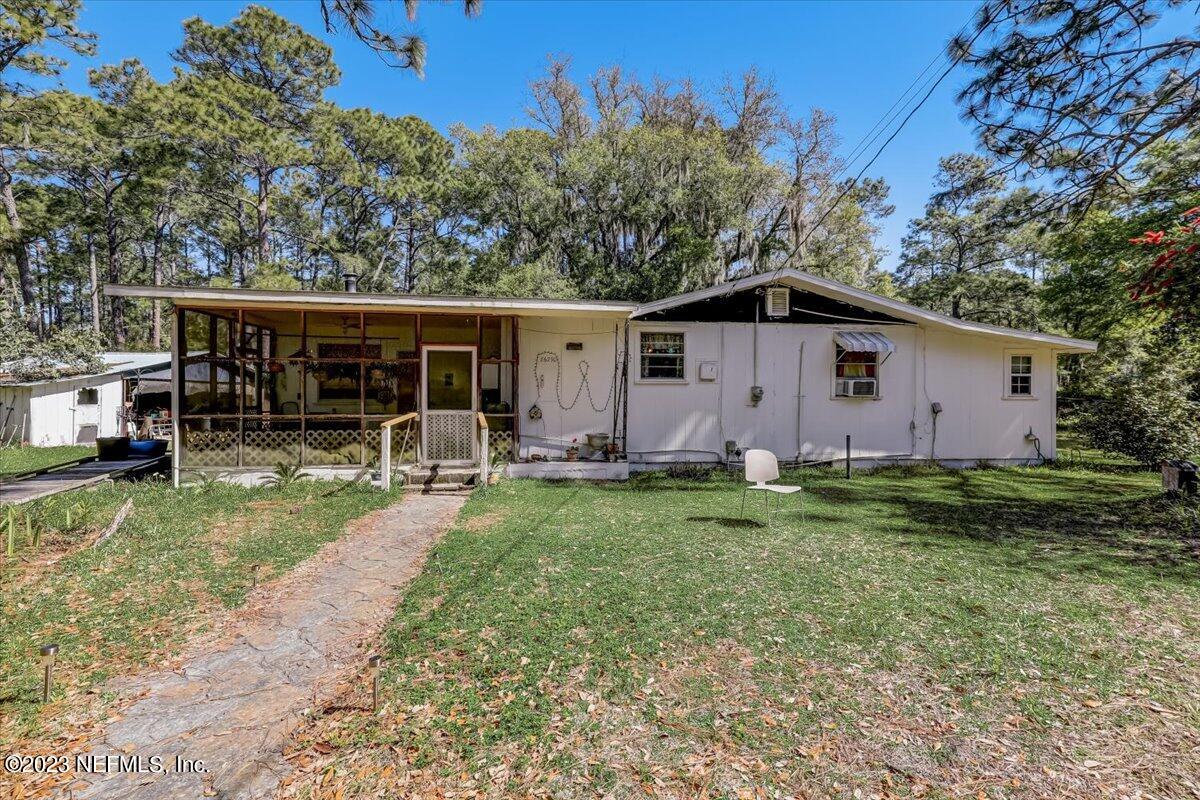 86290 Weldon Road Yulee, FL 32097 - Photo 5 of 46 a view of house with backyard space and garden