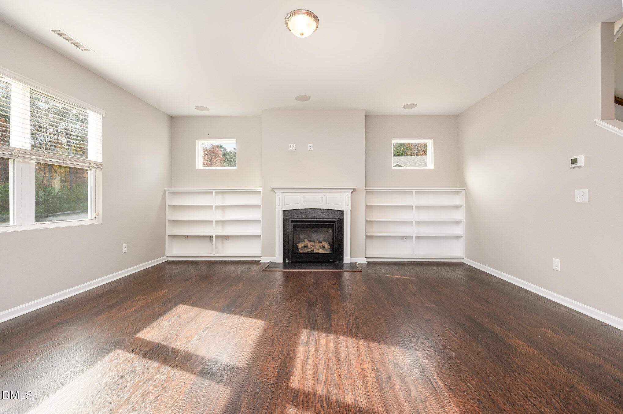 18 Dover Ridge Court Chapel Hill, NC 27517 - Photo 13 of 40 a view of an empty room with wooden floor fireplace and a window