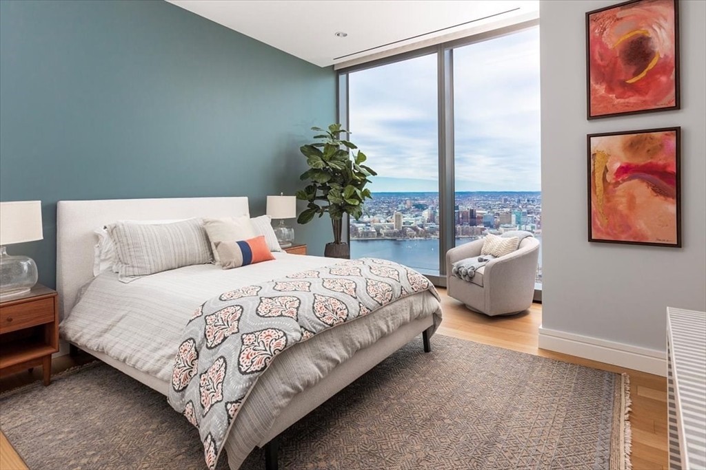 1 Dalton Street, Unit 5402 Boston, MA 02115 - Photo 14 of 17 a bedroom with bed and a large window