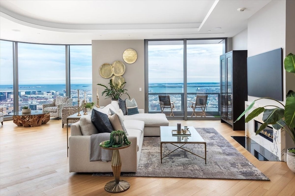 1 Dalton Street, Unit 5402 Boston, MA 02115 - Photo 4 of 17 a living room with fireplace furniture and floor to ceiling windows