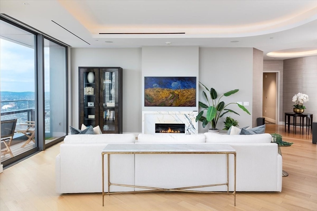 1 Dalton Street, Unit 5402 Boston, MA 02115 - Photo 5 of 17 a living room with fireplace furniture and large windows