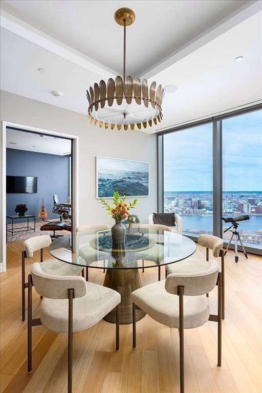 1 Dalton Street, Unit 5402 Boston, MA 02115 - Photo 9 of 17 a living room with couches chandelier and a large window