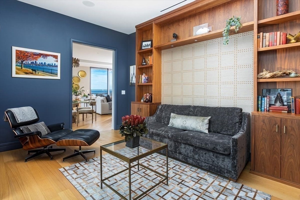 1 Dalton Street, Unit 5402 Boston, MA 02115 - Photo 10 of 17 a living room with furniture and a book shelf