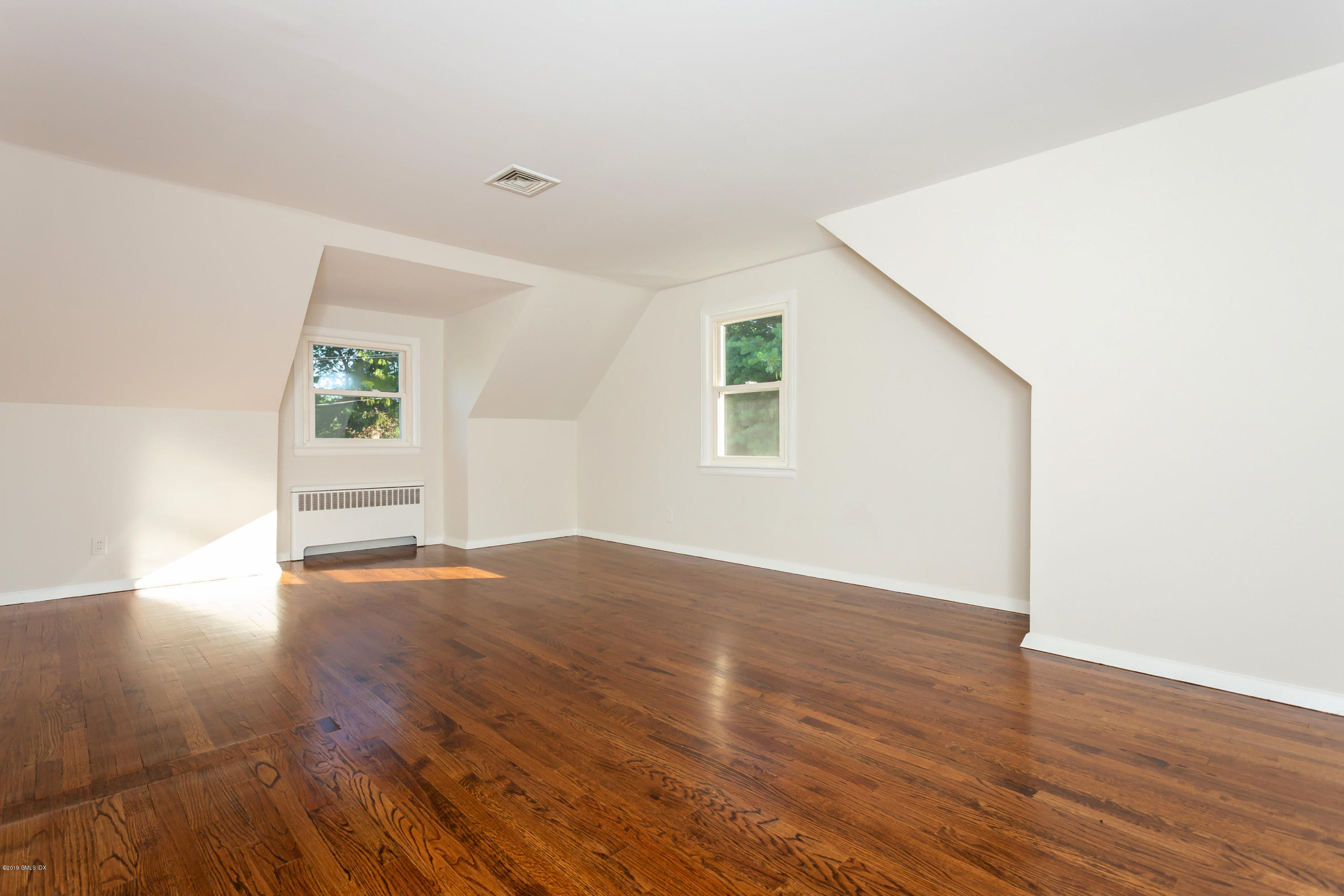 20 Silver Beech Road Riverside, CT 06878 - Photo 18 of 33 an empty room with wooden floor and windows